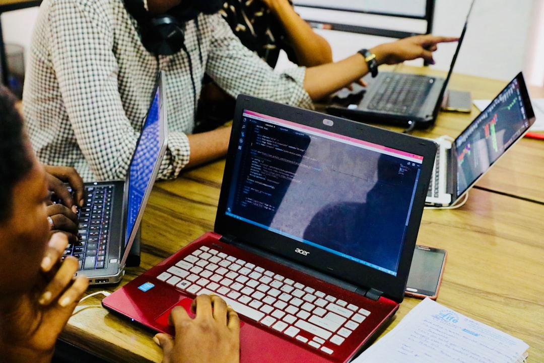 An image showing multiple computer developers working together to solve a problem